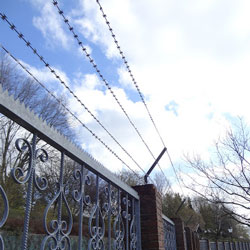 Barbed wire halberd on a metal fence