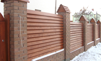 Wooden fence with brick pillars